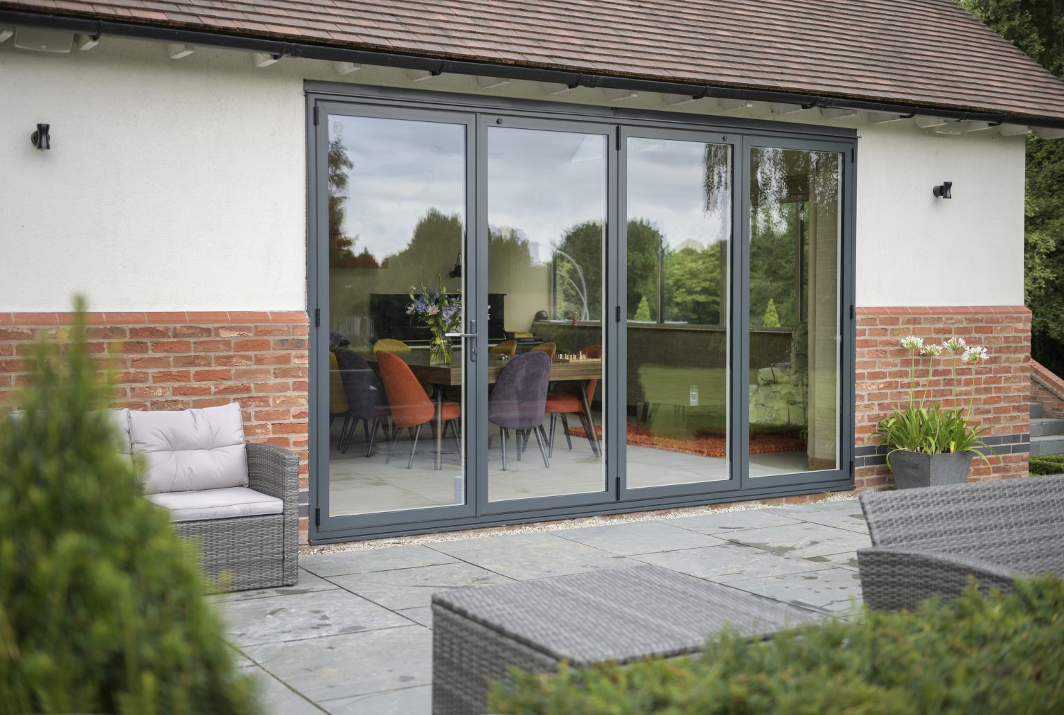 Image of a four section aluminium bifolding door in a home  